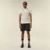 Polo-T-shirt i öppen mesh-stickning